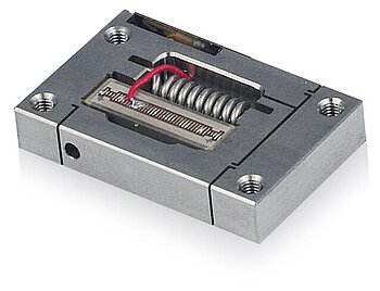 Figure 10. Low-cost piezo flexure amplified actuators for OEM application. The image shows the integrated piezo stack actuator and the preload. A position feedback sensor is optional (Image: PI)